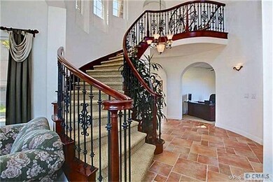 Circular staircase with wrought iron & maple banis