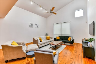 Main living area has a dramatic high ceiling.