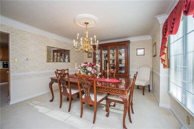 The formal dining room overlooks the front lawn an