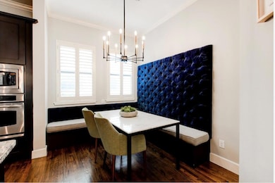 Dining area with a notable chandelier, crown moldi