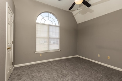 Unfurnished room with a ceiling fan, a textured ce