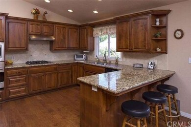 Newer cabinetry, granite slab counters and stainle