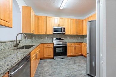 Kitchen with stainless steel appliances, light sto