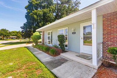 Doorway to property with a lawn