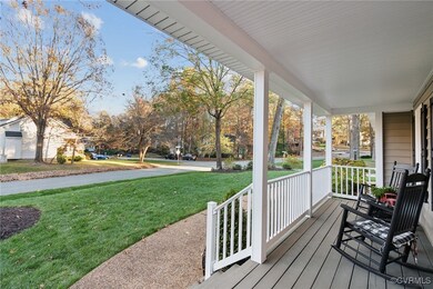 Wooden terrace featuring covered porch and a lawn
