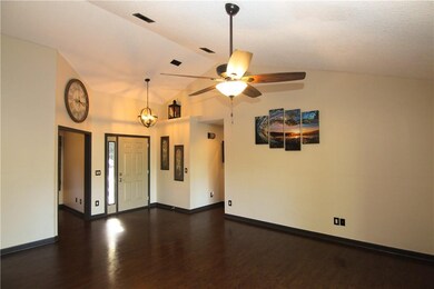 Living room front door view with den to left openi