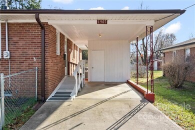 Attached car port with ramp. Small storage area where hot water heater is located.