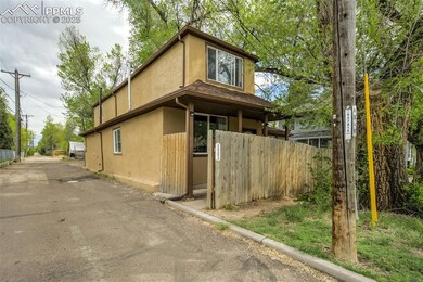 View of property exterior featuring stucco siding and fence