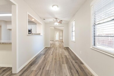 Hall with hardwood / wood-style flooring and a tex