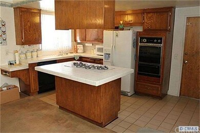 Large Kitchen, wood  cabinets and ceramic tile cou