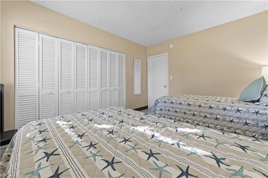 Bedroom with a textured ceiling and a closet