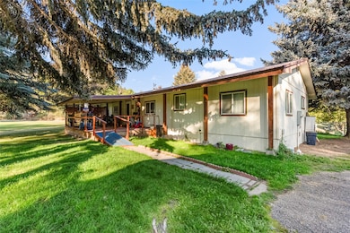 Ranch-style home featuring a deck and a front yard