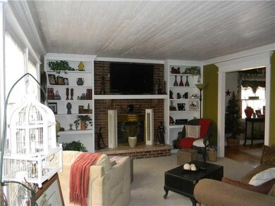 Living Room. Snuggle by the fireplace and read a book from your bookshelves.  Newer carpet and wood ceiling make this a very cozy place to relax