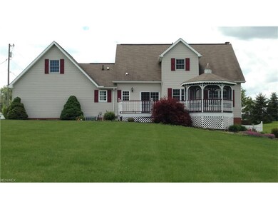 Back of house shows the lush yard, the deck and th