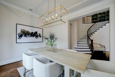 The dining room features designer light fixture an