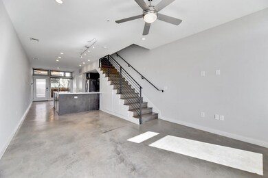 Unfurnished living room with stairway, baseboards