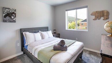 Carpeted bedroom with baseboards and a mountain view
