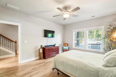 Bedroom featuring wood finished floors and ceiling fan