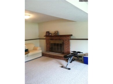 Family room fireplace fitted with gas logs.