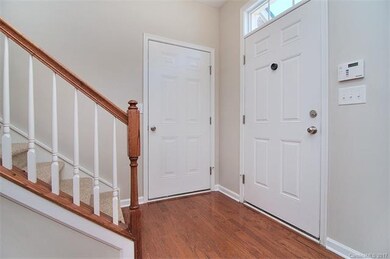 Open Foyer with hardwoods and attached 1-Car Garag