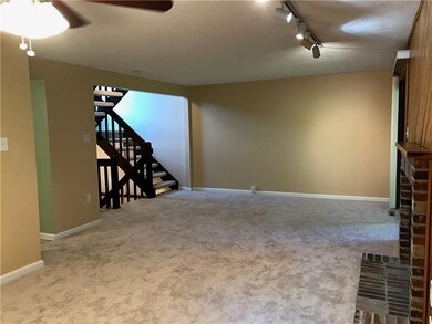 Living room to stairway.  Enjoy New Carpet Through