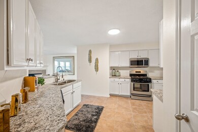 Enjoy generous counter space on these beautiful granite countertops. Notice an abundance of cabinets as well.
