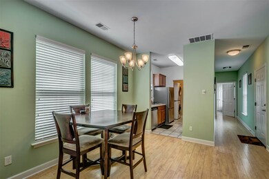 Open Concept Living With Hardwood Floor Continuing