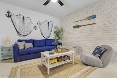 Living room with ceiling fan and tile patterned fl