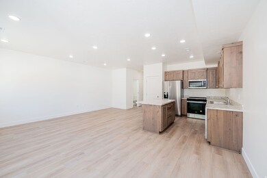 Kitchen featuring a kitchen island, stainless steel appliances, light wood-type flooring, recessed lighting, and open floor plan