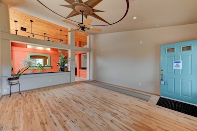 Foyer featuring ceiling fan, wood finished floors,