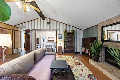 Living room featuring wood finished floors, a bri