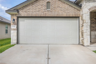 Garage featuring concrete driveway