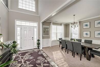 2 story foyer opens onto the stylish dining room w/wainscoting, crown molding, and plenty of natural light.