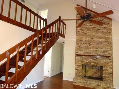Living Room With Grand Staircase & Woodburning Fir