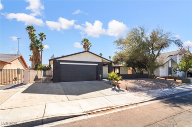 View of front facade with concrete driveway, a garage, a gate, and stucco siding