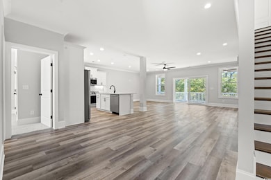 Unfurnished living room with ornamental molding, s