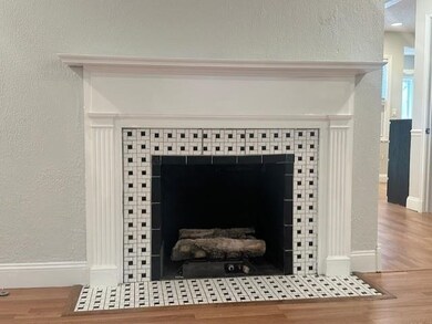 Room details featuring baseboards, a textured wall