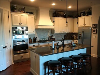 Kitchen has a huge island for casual dining and en