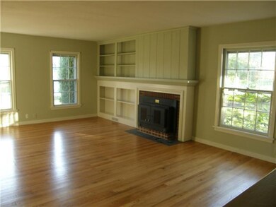 Living Room Shiny hardwoods and built in bookshelv
