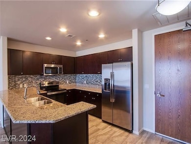 Kitchen with stainless steel appliances, a sink, a
