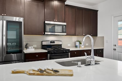 Kitchen featuring backsplash, light countertops, 