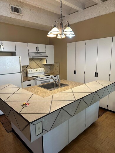 Kitchen with visible vents, stove, a sink, a chan