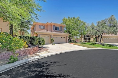 View of front of house featuring stucco siding, driveway, and a garage