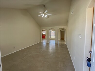 Entering the home you're met with an open living room with grand vaulted ceilings.
