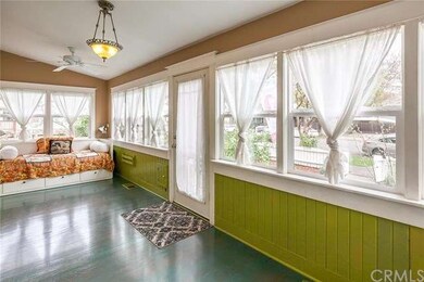 You enter into this Charming Sun porch.