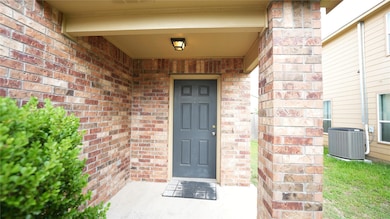 Doorway to property with brick siding and central
