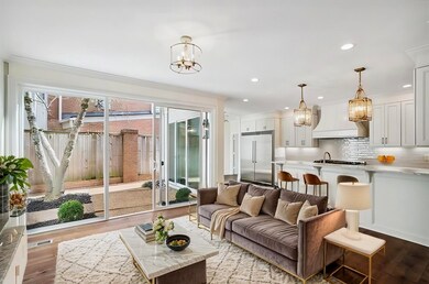 Living room with ornamental molding, light hardwoo