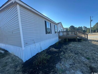 View of property exterior with a wooden deck