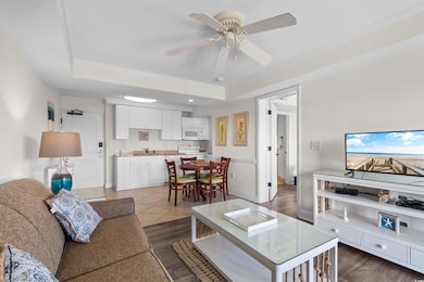 Living room featuring a raised ceiling, dark hardw