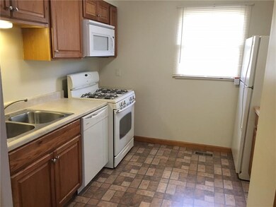 Kitchen - newer cabinetry and clean white applianc
